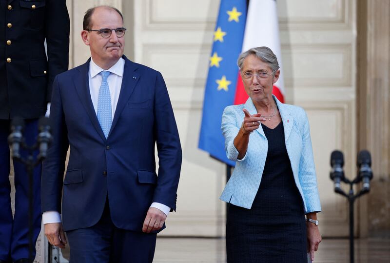 Mr Castex and his successor, Ms Borne, arrive for the handover ceremony. AFP