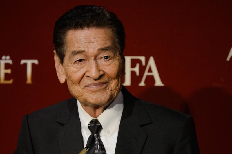 Eddie Garcia of the Philippines poses with his Best Actor award at the 7th Asian Film Awards in Hong Kong on March 18, 2013. The Asian Film Awards, organised by the Hong Kong International Film Festival and held annually since 2007, are aimed at showcasing the region's movie talent.  AFP PHOTO / Philippe Lopez (Photo by PHILIPPE LOPEZ / AFP)