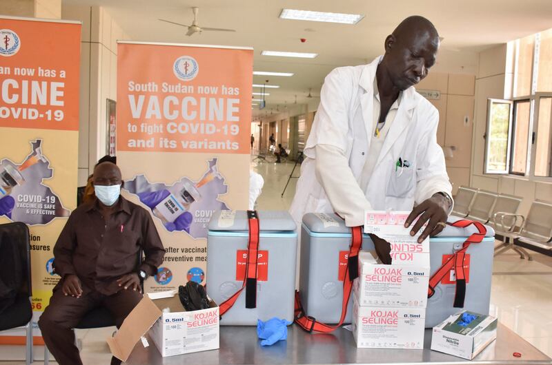 Martin Lako prepares to vaccinate Timon Buga Kujo in Juba, South Sudan. Reuters