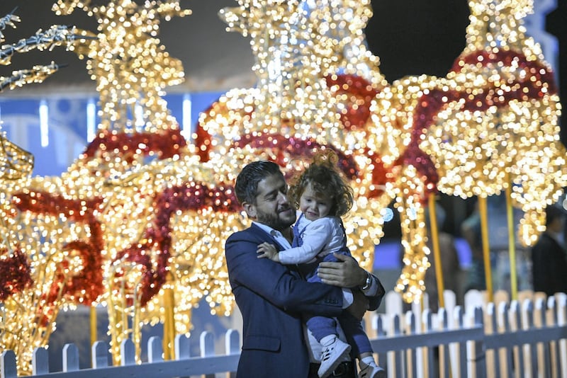 Abu Dhabi, United Arab Emirates - Father and daughter at the Winter Wonderland event on the Galleria Mall promenade. Khushnum Bhandari for The National