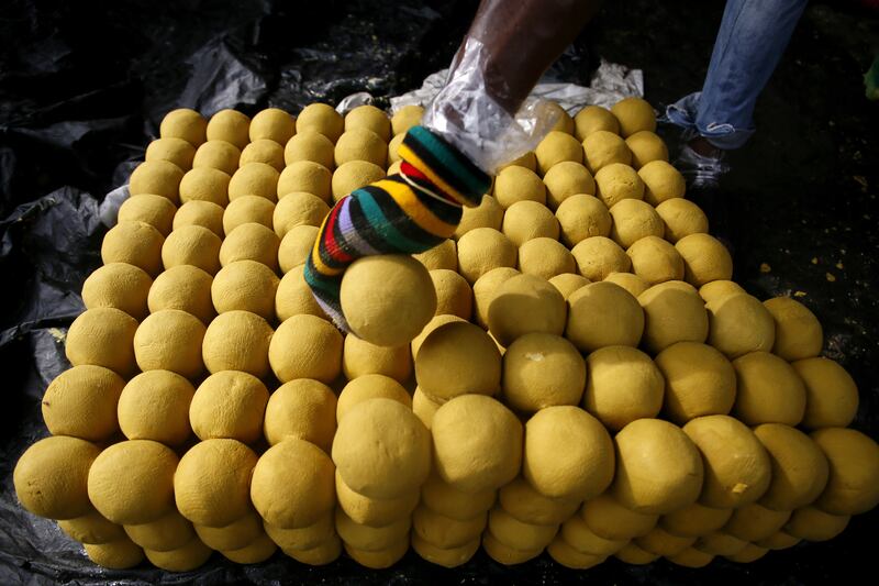 A man packages balls of 'Kabakrou' soap, also called 'soap-stones', in Yopougon, Abidjan, the Ivory Coast. EPA