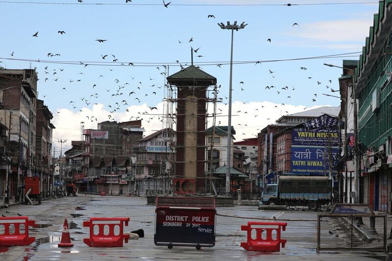 Pigeons fly near deserted Ganta Garh (clock tower)  in Srinagar, India.  EPA