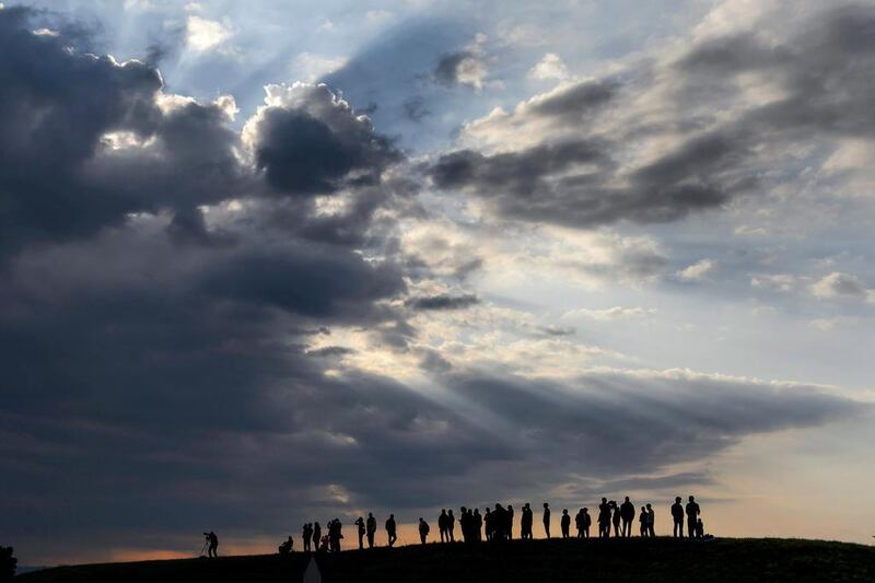Spectators watch Solar Impulse 2 take its maiden flight in Payerne, Switzerland. Solar Impulse 2 is the second plane of the Solar Impulse project, which aims to circumnavigate the world with a solar-powered aircraft. Fabrice Coffrini / AP Photo