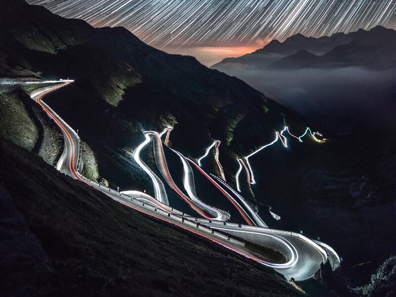 Dark contours of the Stelvio Pass in the Italian Alps in this lime-lapse night photo. Unsplash