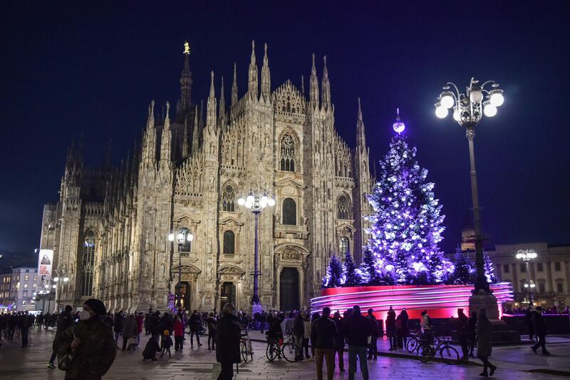epa08875296 Christmas tree is illuminated at the Piazza Duomo near the cathedral in Milan, Italy, 10 December 2020.  EPA/Matteo Corner