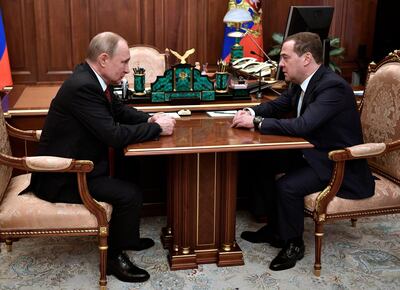 Russian President Vladimir Putin, left, listens to Russian Prime Minister Dmitry Medvedev during their meeting in the Kremlin in Moscow, Russia, Wednesday, Jan. 15, 2020. (Alexei Nikolsky, Sputnik, Kremlin Pool Photo via AP)