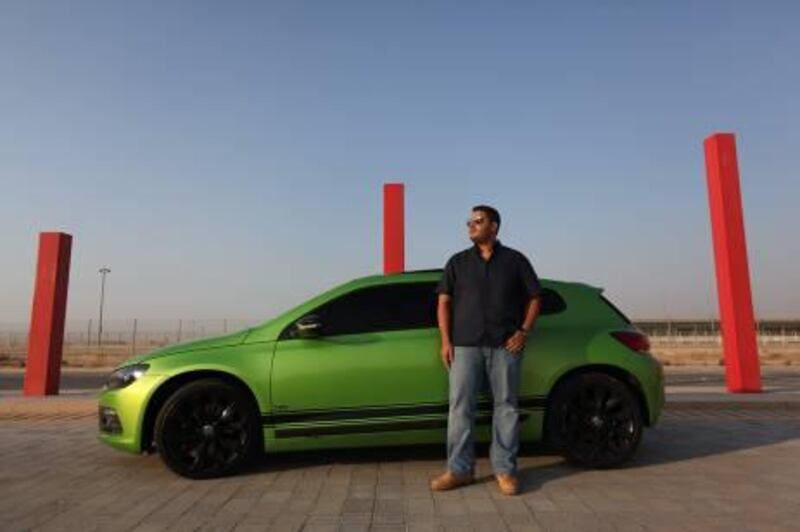 United Arab Emirates - Dubai - November 1, 2010.

ARTS & LIFE: Khaled Wazzan (cq-al), 22, of Dubai, poses for his portrait next to his Volkswagen Scirocco in Dubai Motor City on Monday, November 1, 2010. "It captures attention when you're driving," said Wazzan, a business management student at American University Dubai. When asked whether he likes attention, Wazzan replied, "Of course! Who doesn't?"  Amy Leang