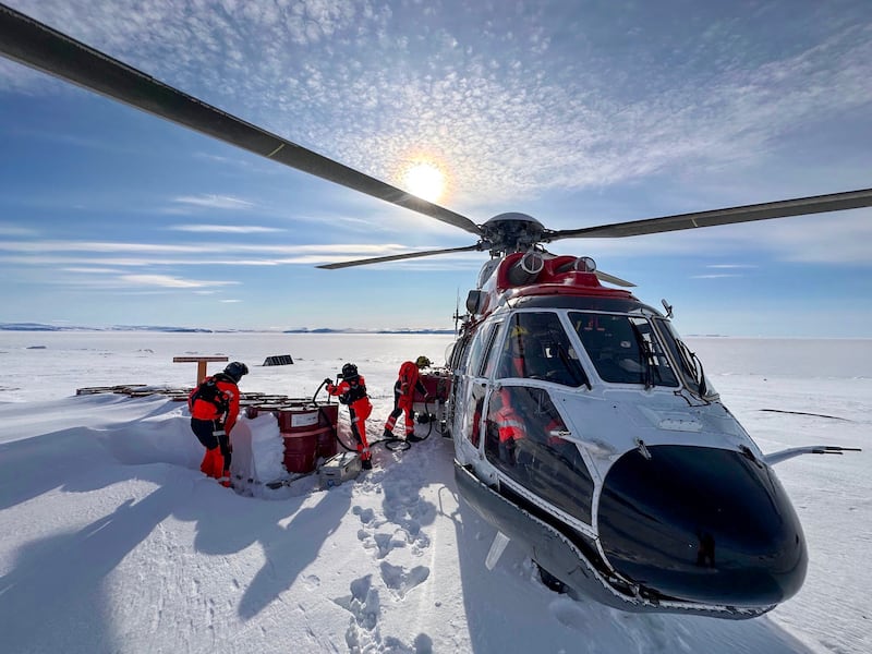 A helicopter refuels en route to Russian scientific vessel Severny Polyus, caught in Arctic ice 440km from the North Pole. AFP