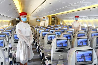Emirates crew wear personal protective equipment (PPE) on flights during the coronavirus pandemic. Courtesy Emirates 