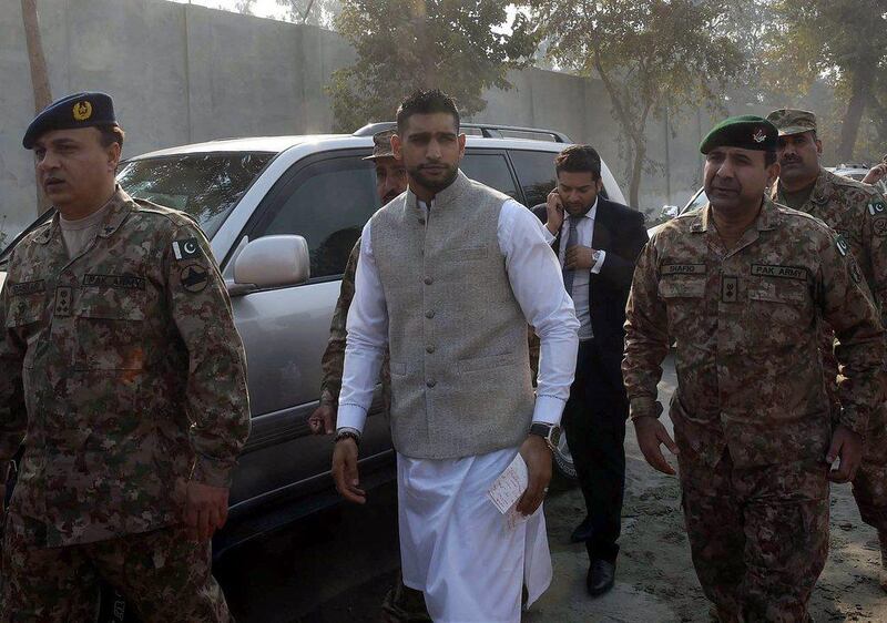Amir Khan is taken to the memorial at the tragedy-struck army-run school in Peshawar, Pakistan on Monday. A Majeed / AFP