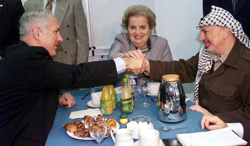 Israeli Prime Minister Benjamin Netanyahu, United States Secretary of State Madeleine Albright and Palestinian leader Yasser Arafat (from L to R) prepare to start their meeting at an Israeli military base at the Erez crossing point, the main point of passage from the Gaza Strip into Israel. The three met for the third time in two weeks in an intensive US push to seal a new interim Mideast peace accord. (Photo by MENAHEM KAHANA / AFP)