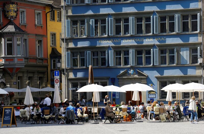 Guests enjoy the sunny weather as they sit in front of a restaurant in Zurich, Switzerland. Reuters
