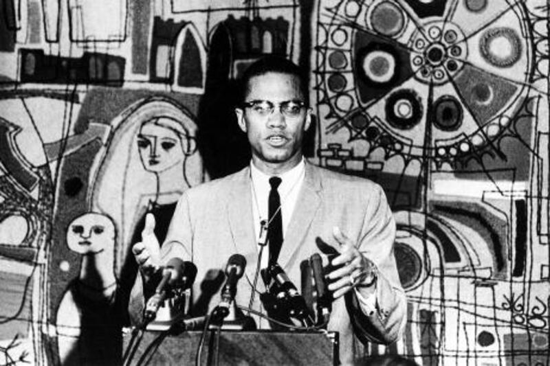 Malcolm X holds a news conference in the Tapestry Suite of Park Sheraton Hotel in New York City on March 12, 1964.  (AP Photo)
