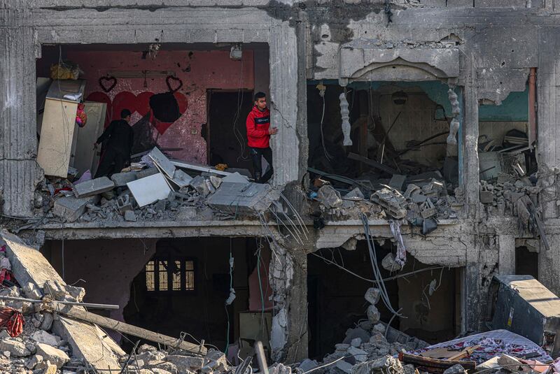 Palestinians inspect a building in Rafah destroyed in an Israeli air strike. AFP