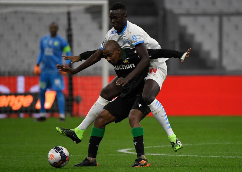 Lens midfielder Gael Kakuta under pressure from Pape Gueye of Marseille. AFP