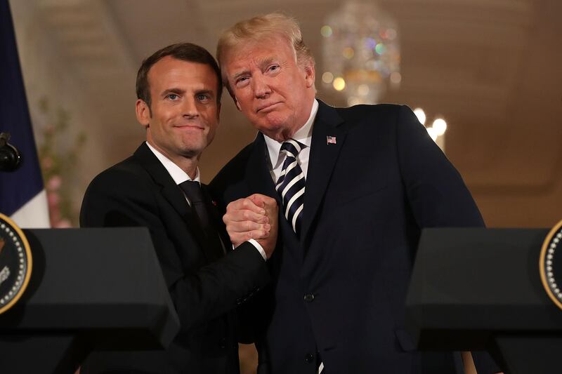 WASHINGTON, DC - APRIL 24:  French President Emmanuel Macron (L) and U.S. President Donald Trump embrace at the completion of a joint press conference in the East Room of the White House April 24, 2018 in Washington, DC. Macron and Trump met throughout the day to discuss a range of bilateral issues as Trump holds his first official state visit with the French president.  (Photo by Chip Somodevilla/Getty Images)