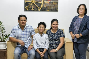 Peter Rosalita, 10, with his parents Ruel Rosalita and Vilma Villegas in Abu Dhabi. The National 