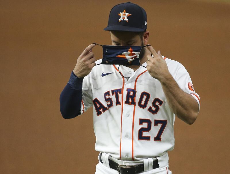 Houston Astros second baseman Jose Altuve puts on a mask before a game against the San Francisco Giants at Minute Maid Park in Houston, Texas, US. Reuters