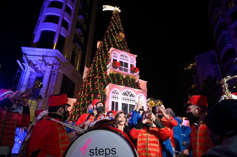 Lebanese people gather next to a giant Christmas tree which has been officially lit up at the Ashrafieh area in Beirut, Lebanon.  EPA