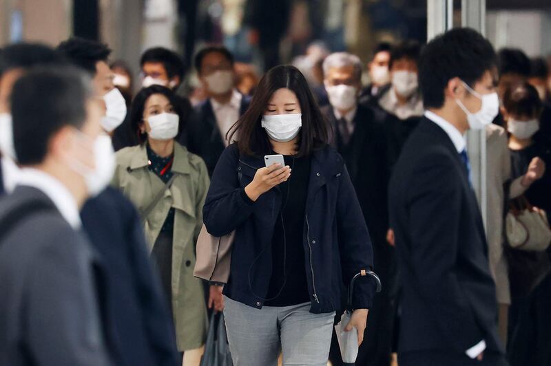 Commuters make their way at Nagoya station in Japan. Kyodo News via AP