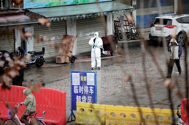 A worker in a protective suit is seen at the closed seafood market in Wuhan, the city in China's Hubei province where the novel coronavirus was first detected, on January 10, 2020. Reuters