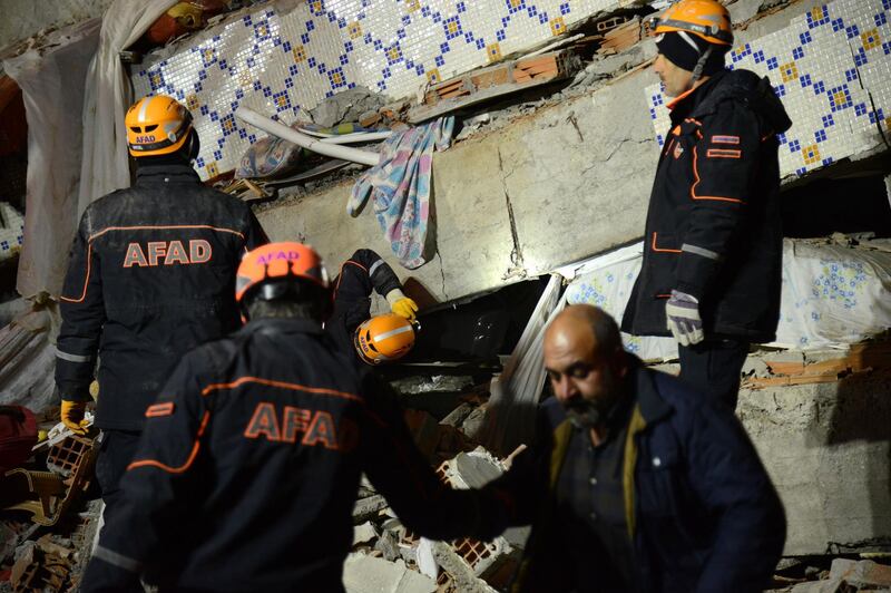 Turkish rescue and police work at the scene of a collapsed building following a 6.8 magnitude earthquake in Elazig, eastern Turkey.  AFP