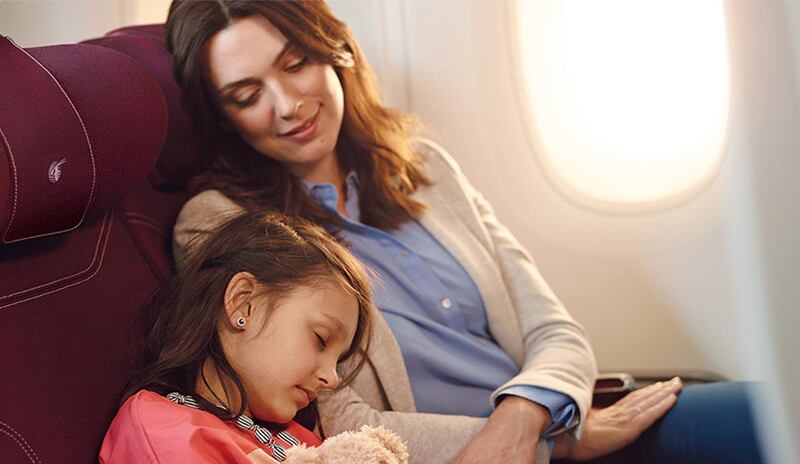 Cabin crew distribute activity packs filled with soft toys, colouring books and more on Qatar Airways. Photo: Qatar Airways