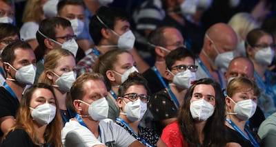 People wear face masks as German pop singer Tim Bendzko performs on stage at the Arena in  Leipzig, eastern Germany on August 22, 2020 where the University of Halle is holding an experiment on the possibilities of hosting concerts and social distancing methods. Tim Bendzko, has agreed to take part in the test by giving three concerts in different configurations in Leipzig during the day, in order to give the researchers the opportunity to find out what the best possible organisation could be in order to avoid contamination. - Germany OUT
 / AFP / dpa / Hendrik Schmidt
