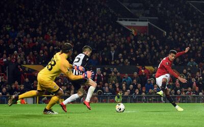 Manchester United's striker Mason Greenwood (R) shoots to score the opening goal past FK Partizan's Serbian goalkeeper Vladimir Stojkovic (L) during the UEFA Europa League Group L football match between Manchester United and Partizan Belgrade at Old Trafford in Manchester, north west England, on November 7, 2019.  / AFP / Oli SCARFF                          
