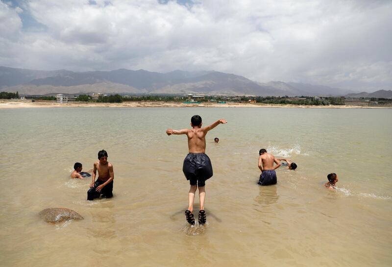 Boys swim in the Qargha lake in Kabul, Afghanistan. Mohammad Ismail / Reuters