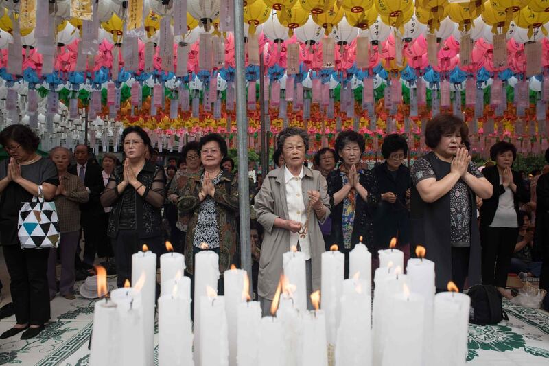 Worshippers offer prayers marking Buddha's birthday at a temple in Seoul. Ed Jones / AFP