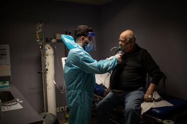 A patient with Covid-19 symptoms is checked by a staff member at Saint George Hospital in Lebanon's capital Beirut. Getty