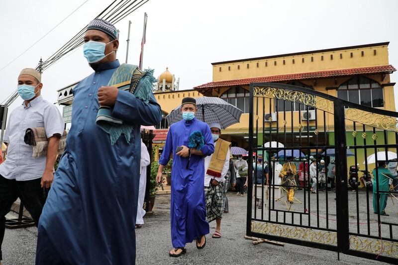 Muslims wearing protective face masks leave a mosque after Eid al-Adha prayers, amid the coronavirus disease (COVID-19) outbreak in Kuala Lumpur, Malaysia July 31, 2020. REUTERS/ Lim Huey Teng
