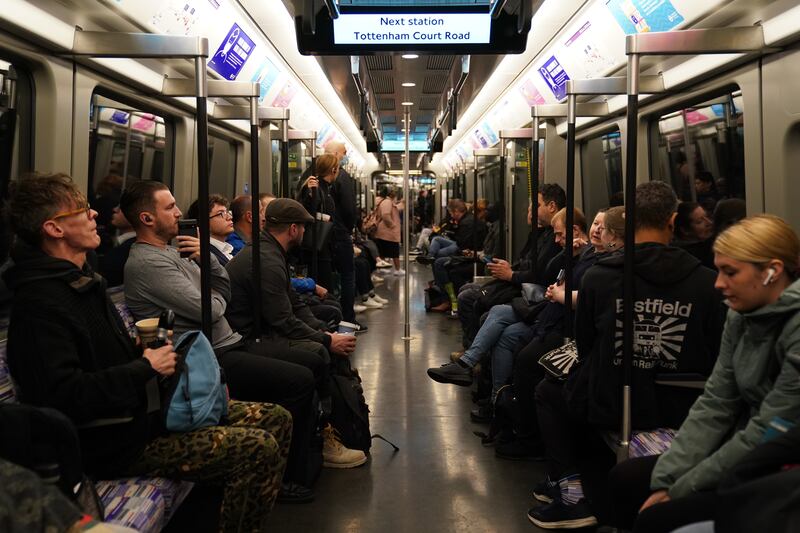 Passengers on an Elizabeth line train approaching Tottenham Court Road station. PA