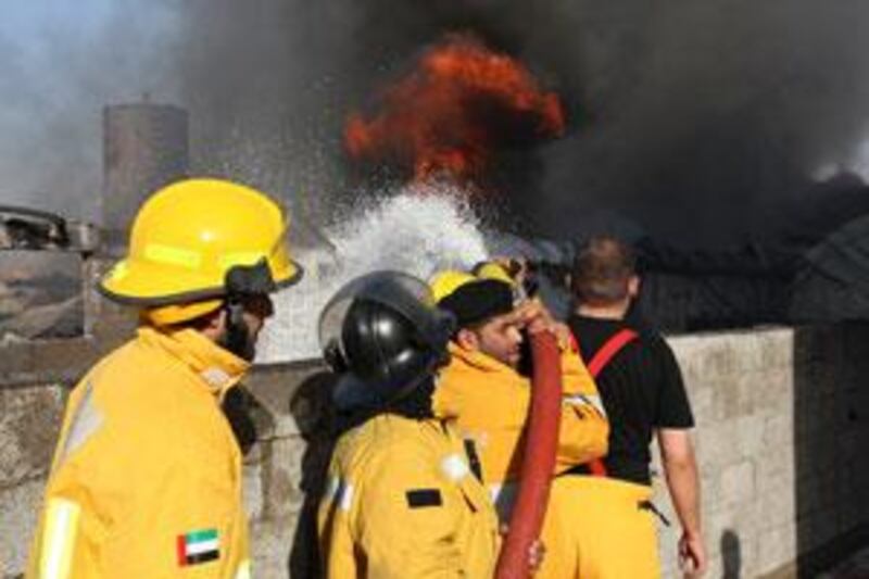 Civil Defence firefighters try to control the fire which broke out in Ajman.