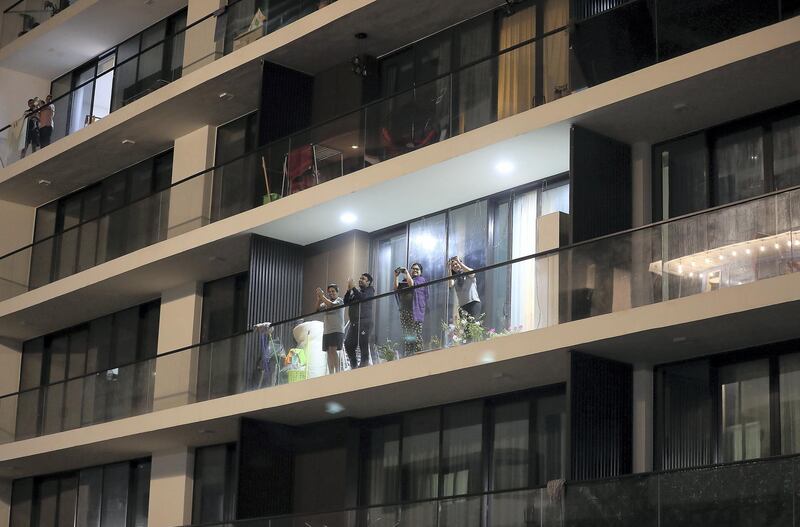 DUBAI, UNITED ARAB EMIRATES , March 25 – 2020 :- UAE residents cheering from their balconies and homes on Wednesday night at Al Mankhool area in Bur Dubai for doctors and medical staff for their tireless efforts in these critical times in Dubai. (Pawan Singh / The National) For News/Online/Standalone/Instagram