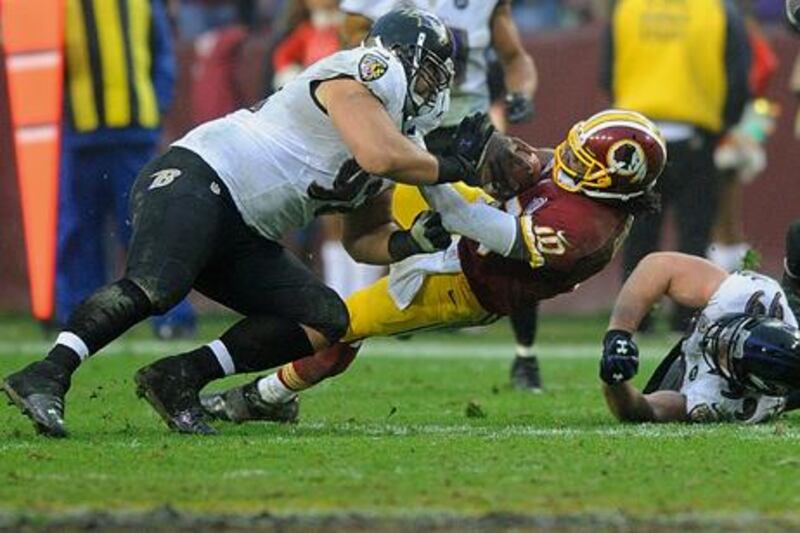 Washington quarterback Robert Griffin III is hit by Baltimore defensive end Haloti Ngata.
