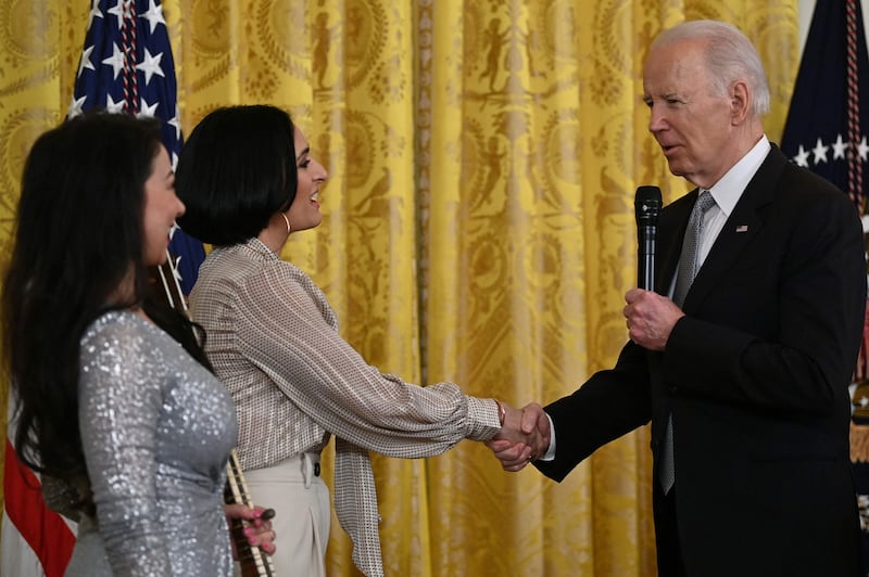 US President Joe Biden greets musician Sahba Motallebi and Iranian-US singer-songwriter Rana Mansour during the Nowruz reception in the White House on Monday. AFP