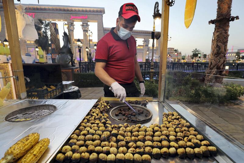 Dubai, United Arab Emirates - Reporter: Janice Rodrigues. Lifestyle. Food. Mikail Alp roasts chestnuts at Gobal Village. Dubai. Sunday, January 17th, 2021. Chris Whiteoak / The National