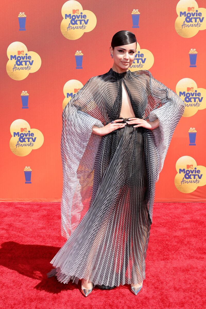 Sofia Carson wearing a flowing grey gown. AFP