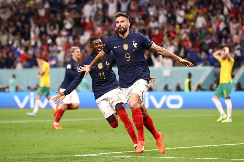 Olivier Giroud celebrates scoring France's second goal, his 50th for his country, with teammate Ousmane Dembele. Getty