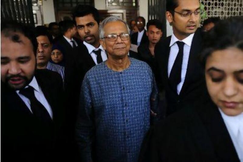 Muhammed Yunus, centre, emerges from the High Court in Dhaka, where he has been fighting the decision to remove him from his post in the Grameen Bank.