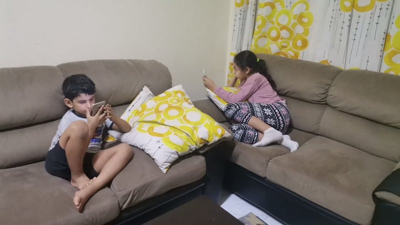 Tala Saadi, from Jordan, says her children Juman, 10, and Rayan, 7, spend the extended weekend at home watching content on their tablets. Photo: Tala Saadi