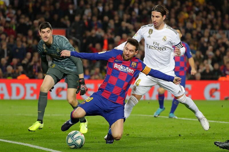 Barcelona's Lionel Messi in action with Real Madrid goalkeeper Thibaut Courtois and Sergio Ramos. AP