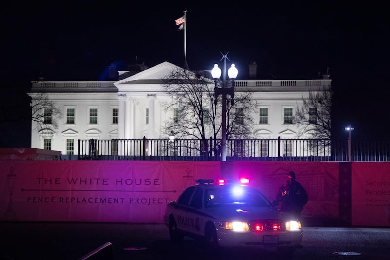 A member of the Uniform Division of the US Secret Service stands on Pennsylvania Avenue outside the White House in Washington during Tuesday night.  EPA