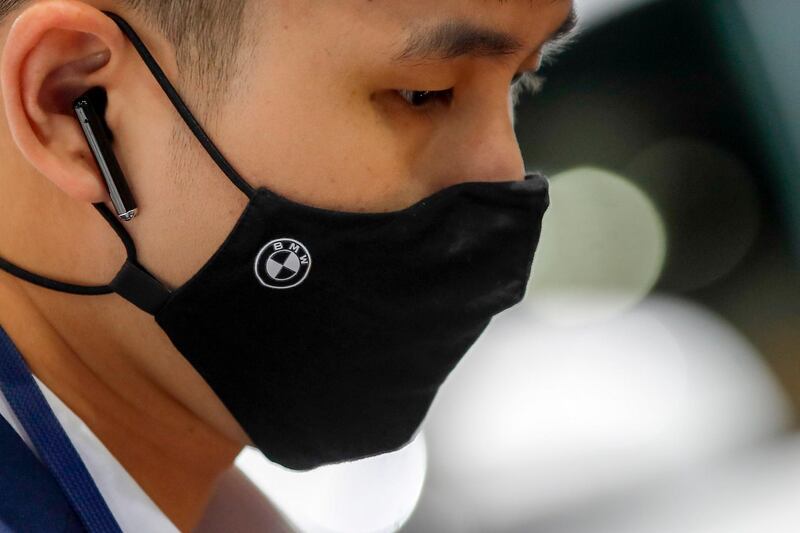 A BMW worker wears a protective face mask at the 41st Bangkok International Motor Show 2020 in Bangkok, Thailand. EPA