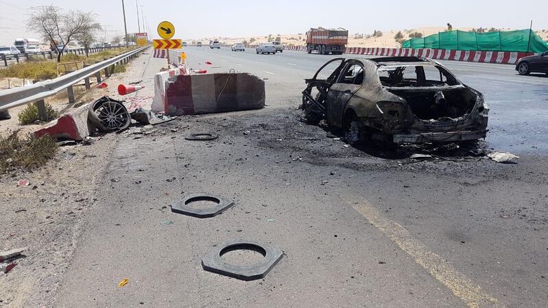 The burnt out vehicle on Emirates Road. Courtesy Dubai Police