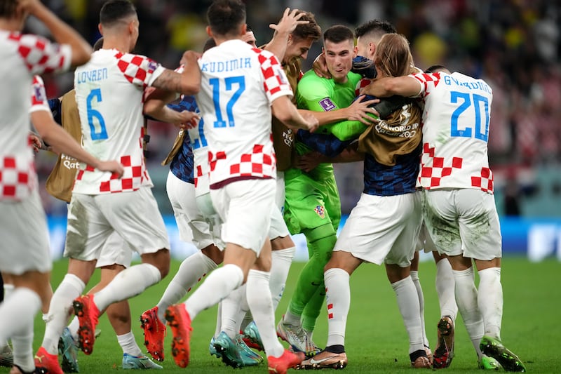 Croatia goalkeeper Dominik Livakovic celebrates with team-mates after winning the penalty shoot-out. PA