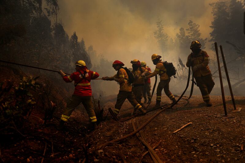Firefighters tackle a wildfire in Santa Juana, Chile, on Friday. Reuters