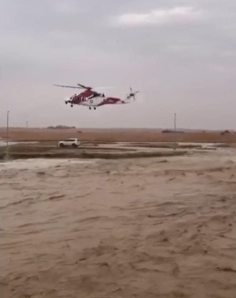 A screenshot of the video showing the NSRC helicopter was able to land on the small island in the middle of the Wadi where Emirati man and his wife  were trapped and the team managed to evacuate them to safety. National Center for Search and Rescue said the centre received a call around 3pm about an Emirati man and his wife being surrounded by floods after their car got stuck in a wadi located in Al Bateen area in Al Ain Wadis on Saturday. Courtesy NSRC 